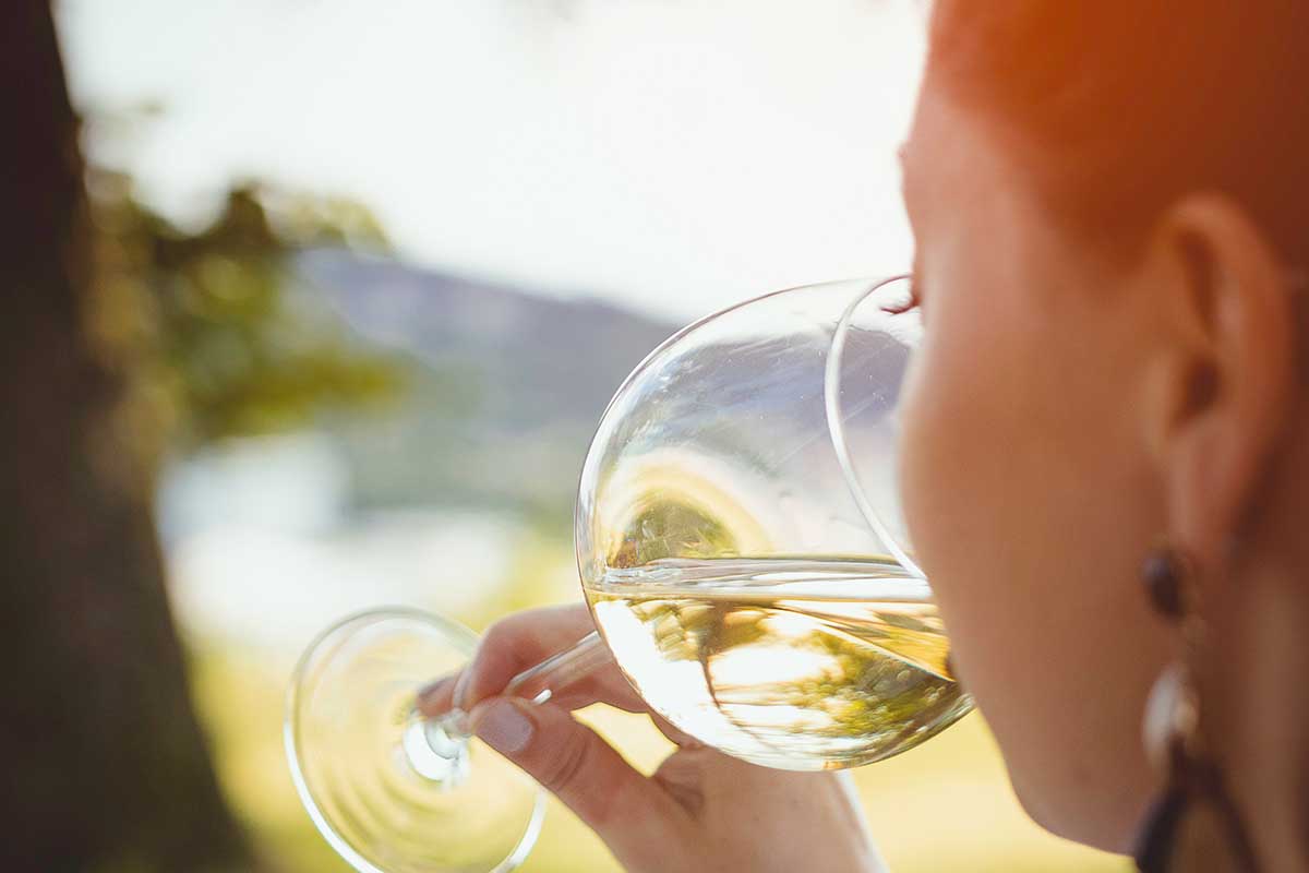 Woman drinking white wine.
