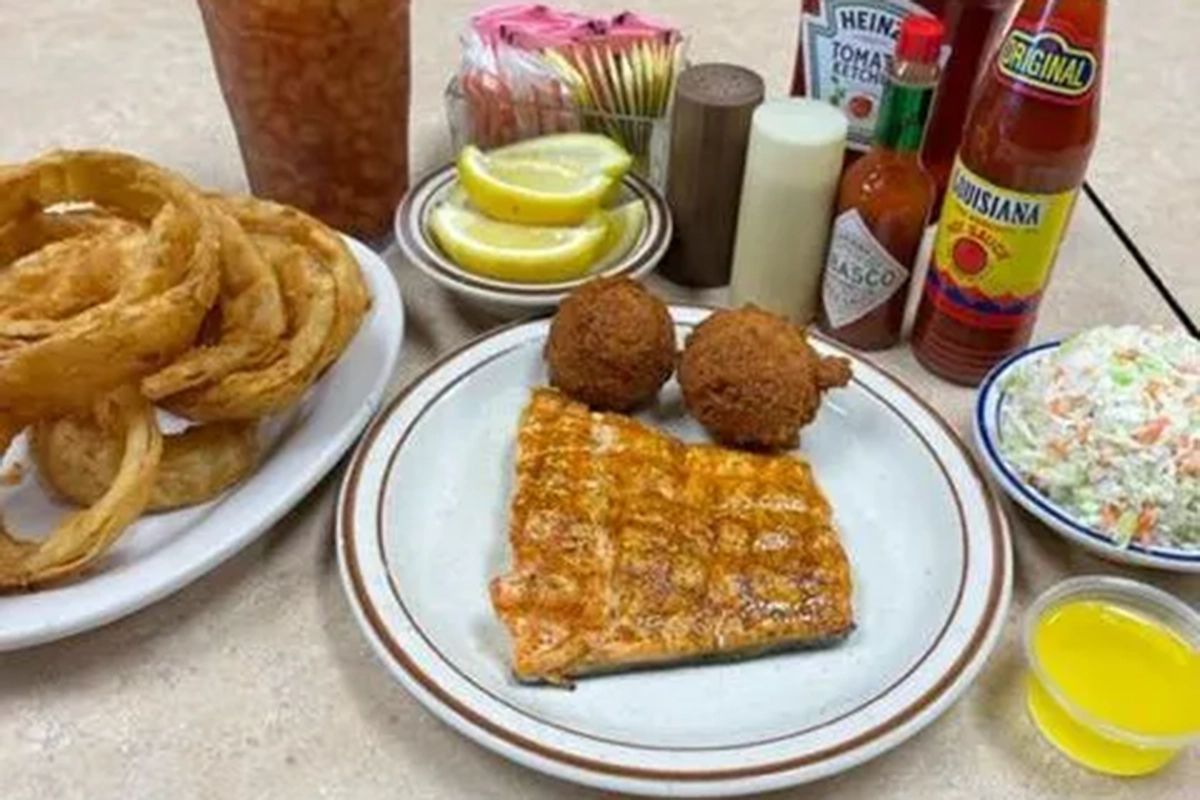 Seafood surrounded by sauces.