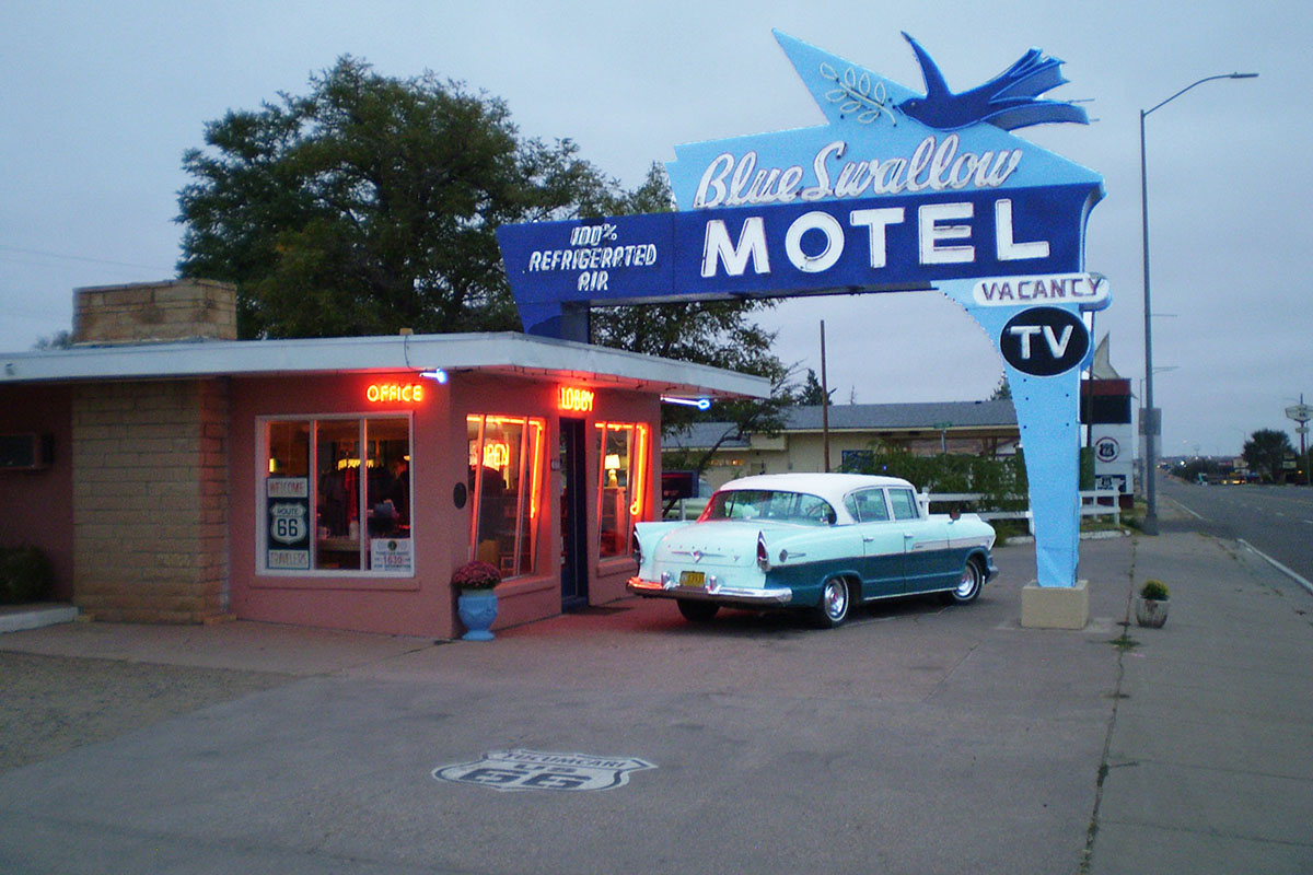 Classic motel on Route. 66 with 53 Chevy parked outside.