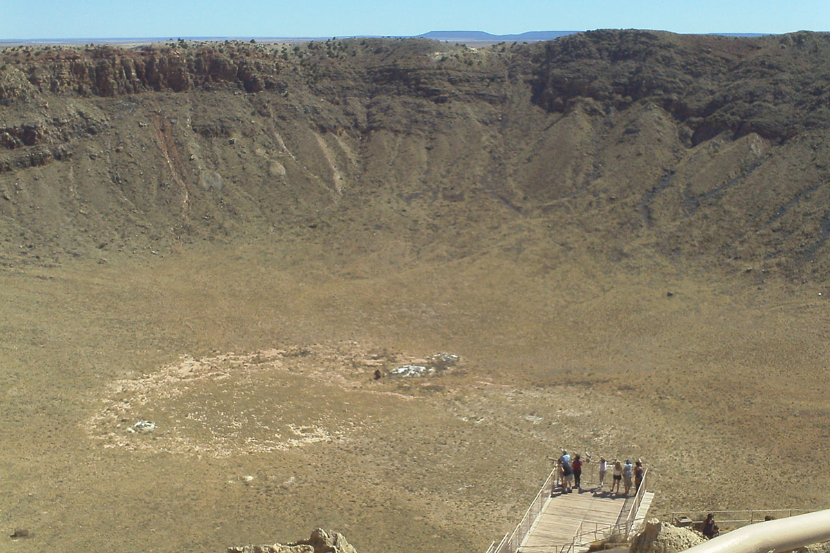 Sightseers looking into massive crater.