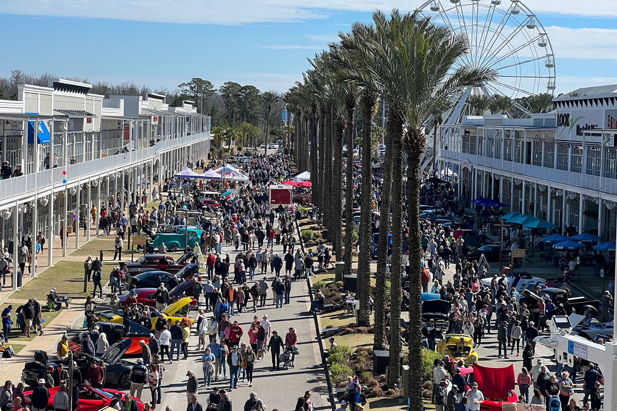 Festival attendees peruse classic cars.