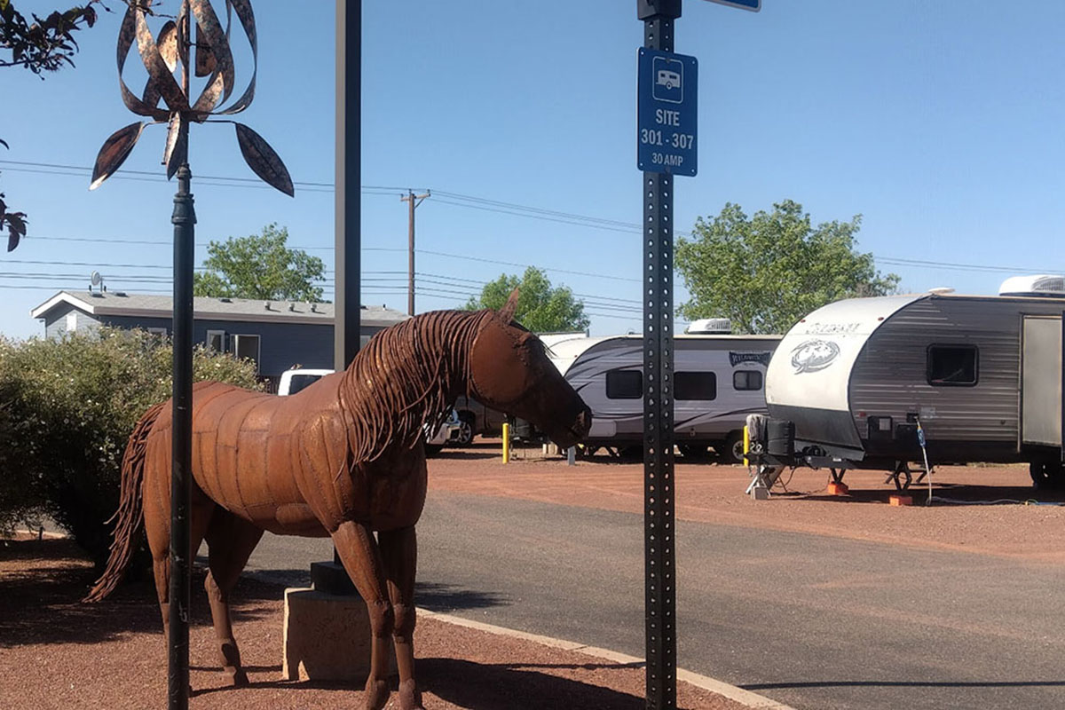 RVs near statue of horse.