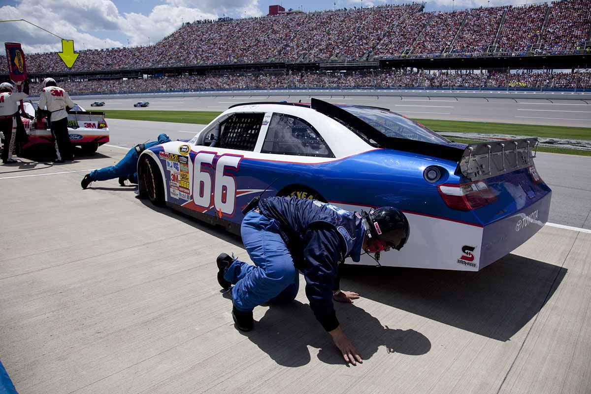 Man working on NASCAR racer. 