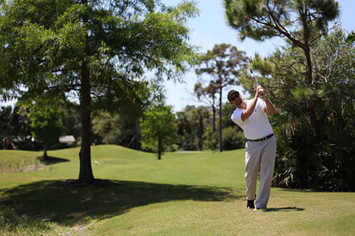 Golfing on undulating fairway. 