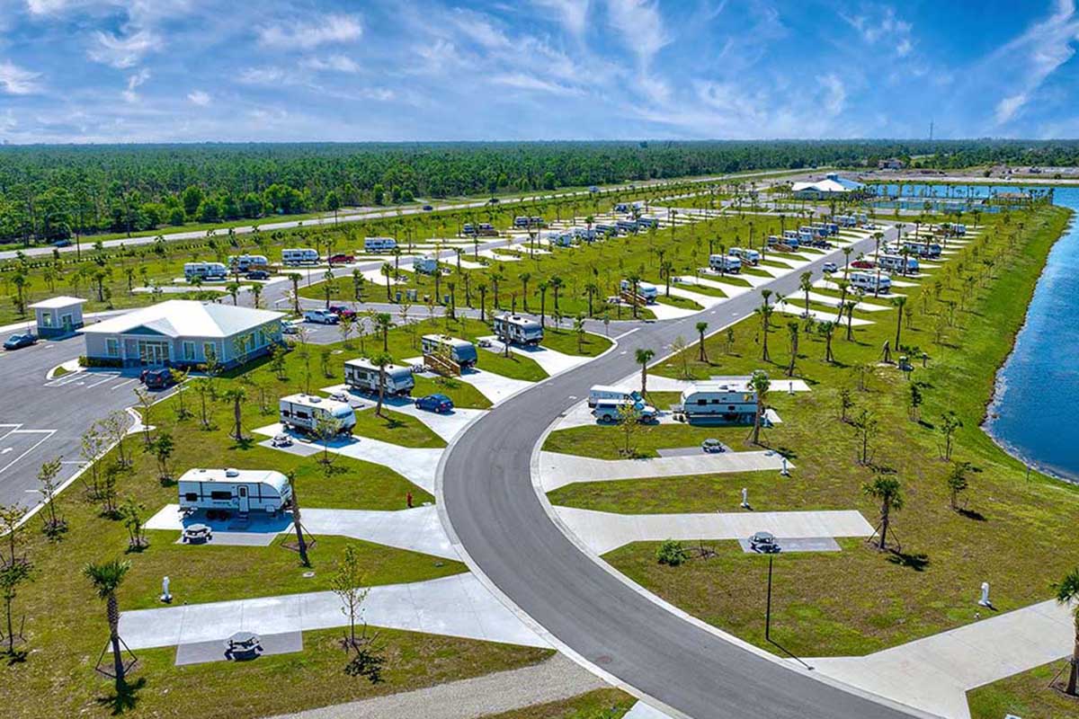 Aerial shot of lake surrounded by RV spaces.