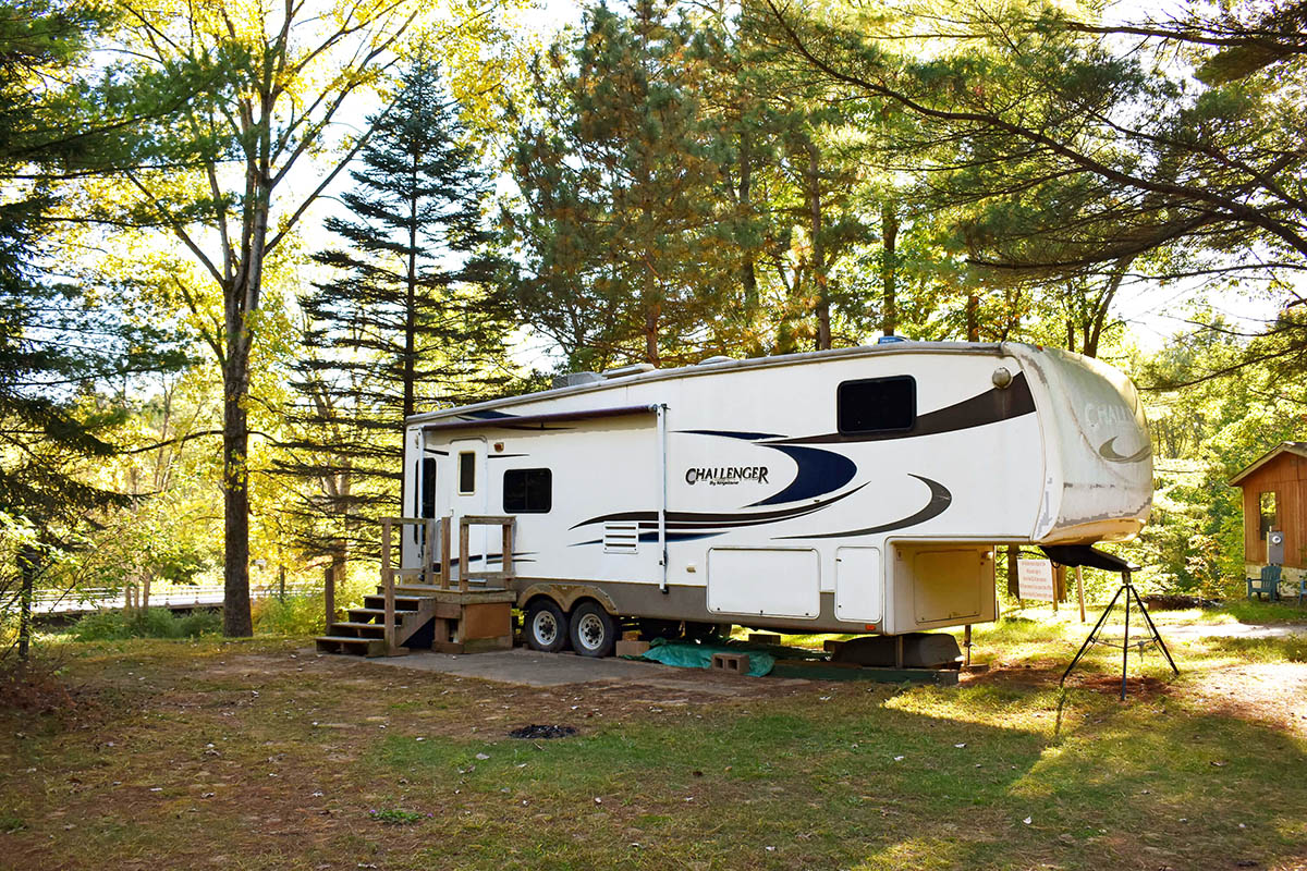 Fifth-wheel in well-appointed campsite.
