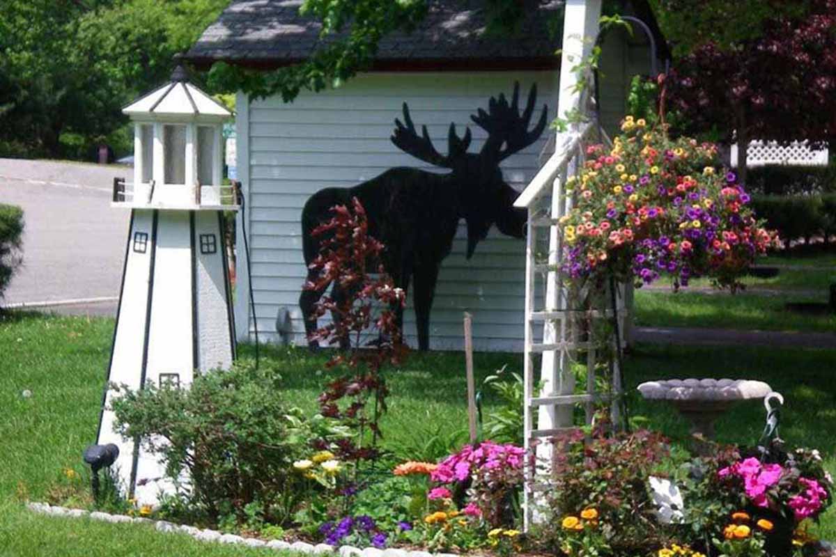 Landscape with lighthouse and moose decorations.