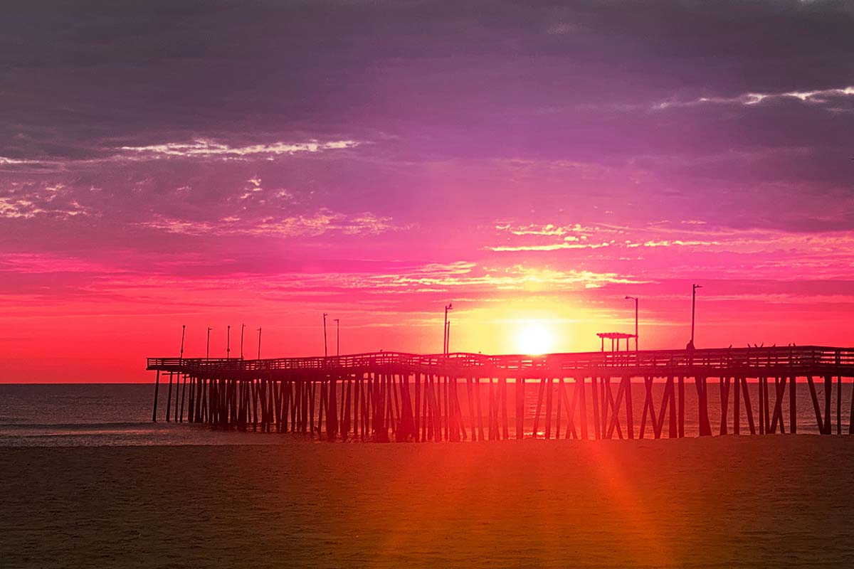 Crimson sunset over pier